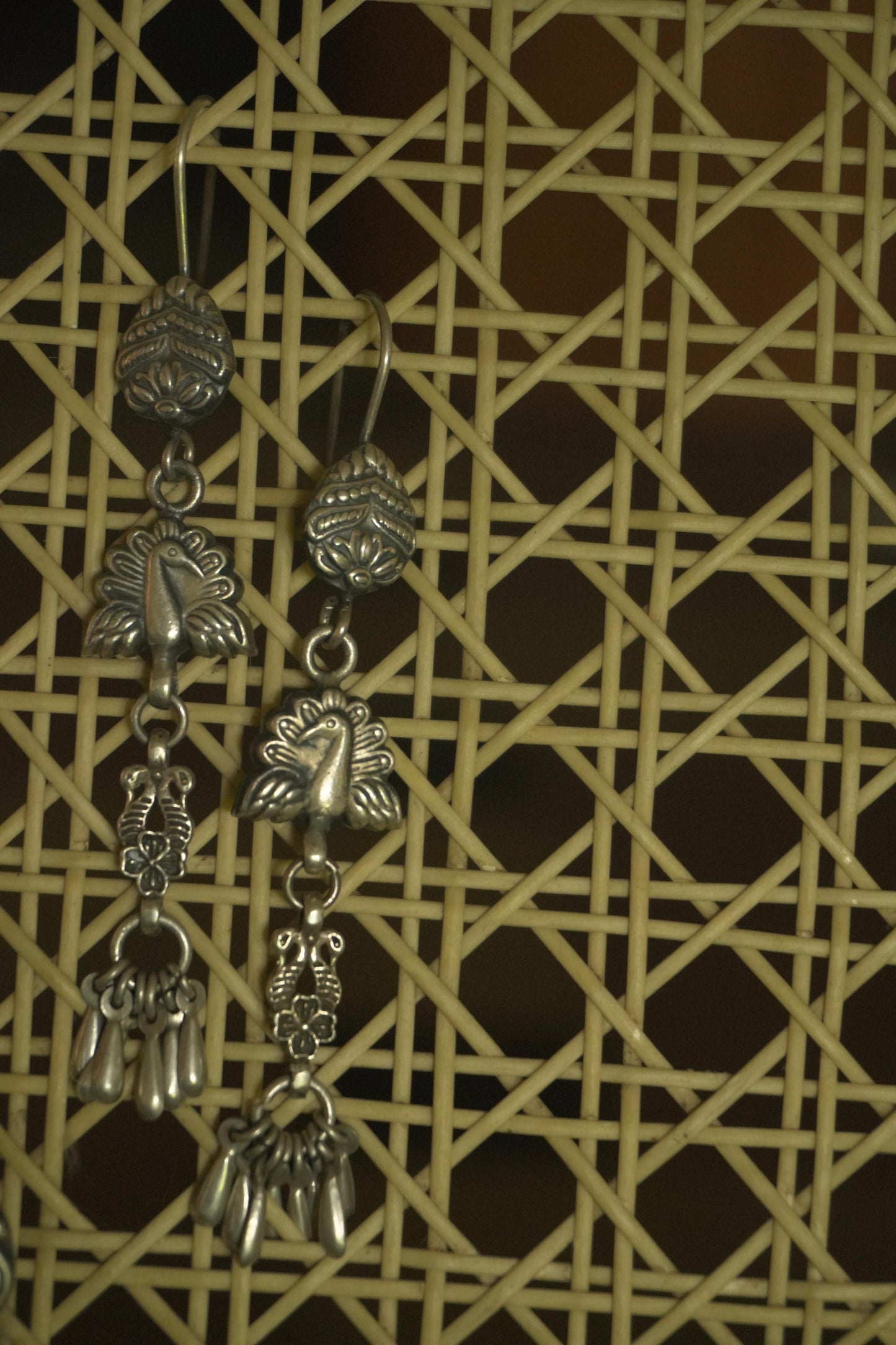Long tribal silver jewellery earrings with intricate 92.5 silver filigree and dangling charms.