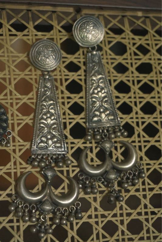 Dangling tribal silver jewellery earrings with detailed floral engravings and 92.5 silver finish.