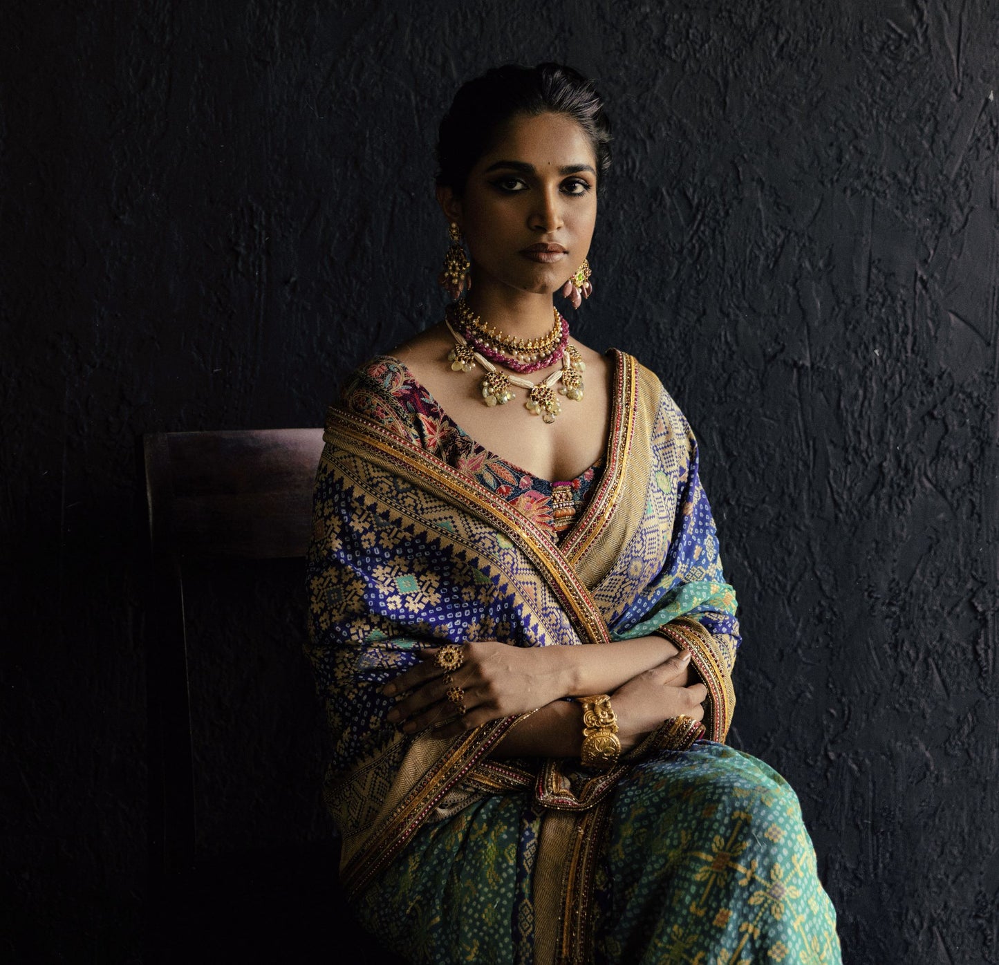 Model wearing Abharika temple earrings with traditional Indian jewelry set and embroidered saree - Aaharya