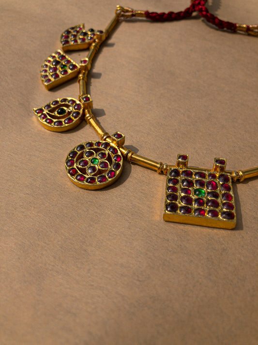 Close-up detail of Raani Maalai showing royal motifs - shield, moon, mango, fan, horse with kemp stone setting