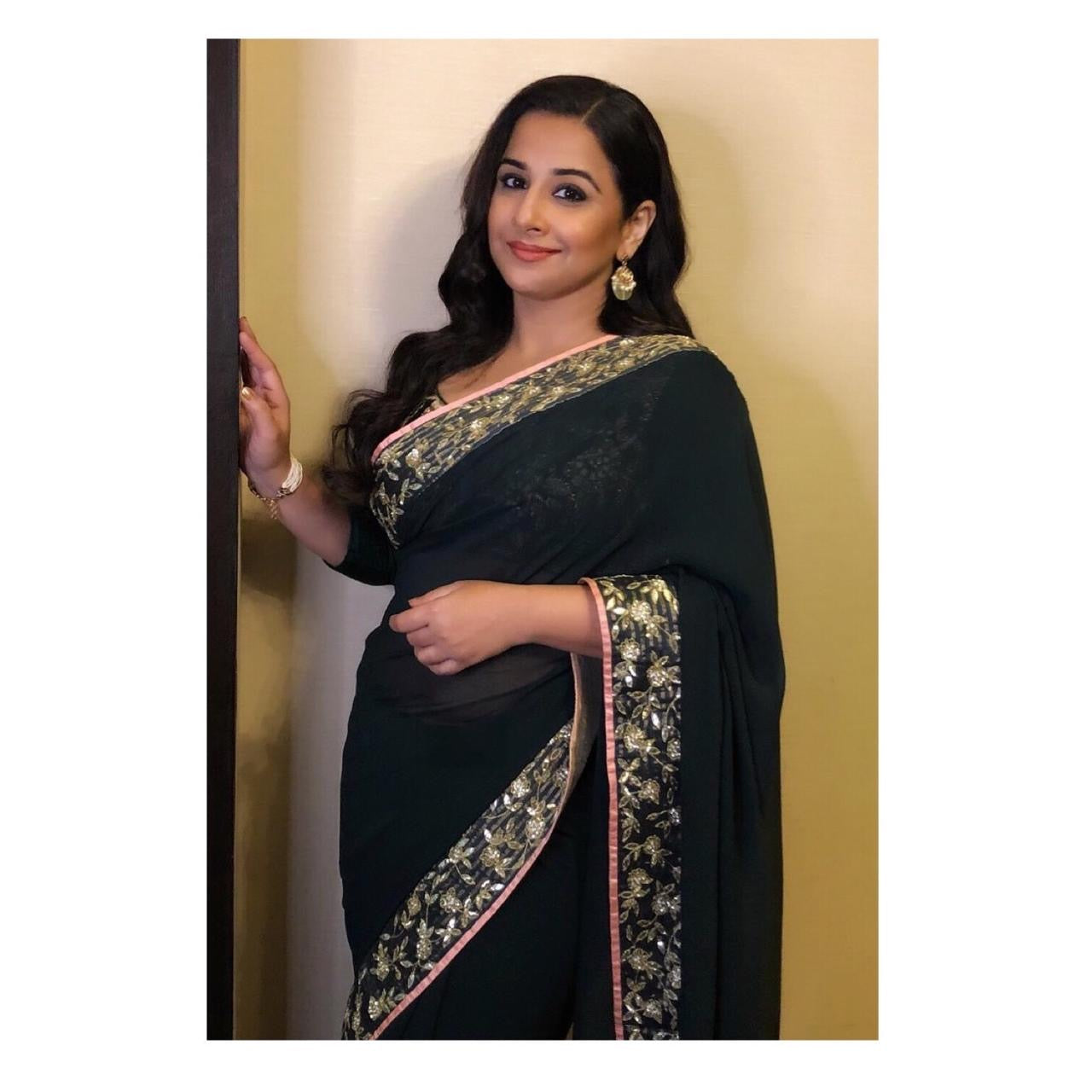 Celebrity Vidya Balan wearing Abharika temple jewelry collection including earchain cum bracelet with traditional Indian attire