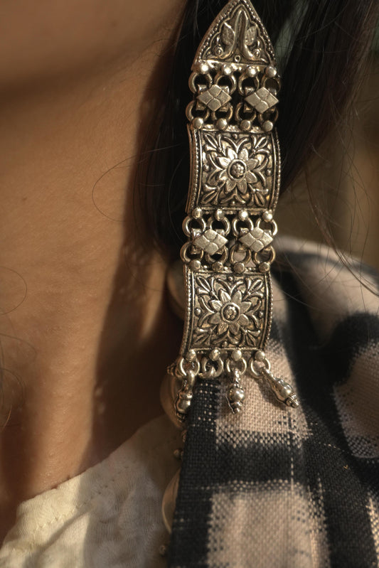 Long tribal silver jewellery earrings with intricate floral and geometric patterns in 92.5 silver.