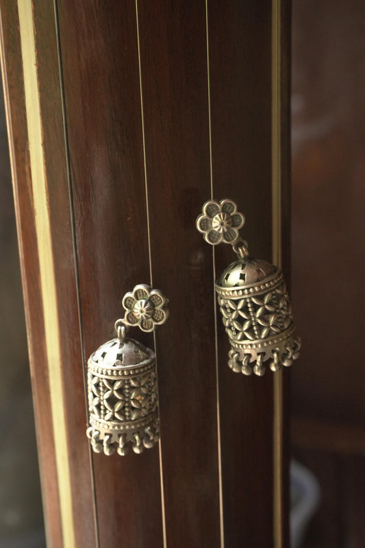 Intricately carved silver jhumka earrings with floral tops, 92.5 silver tribal jewellery design.