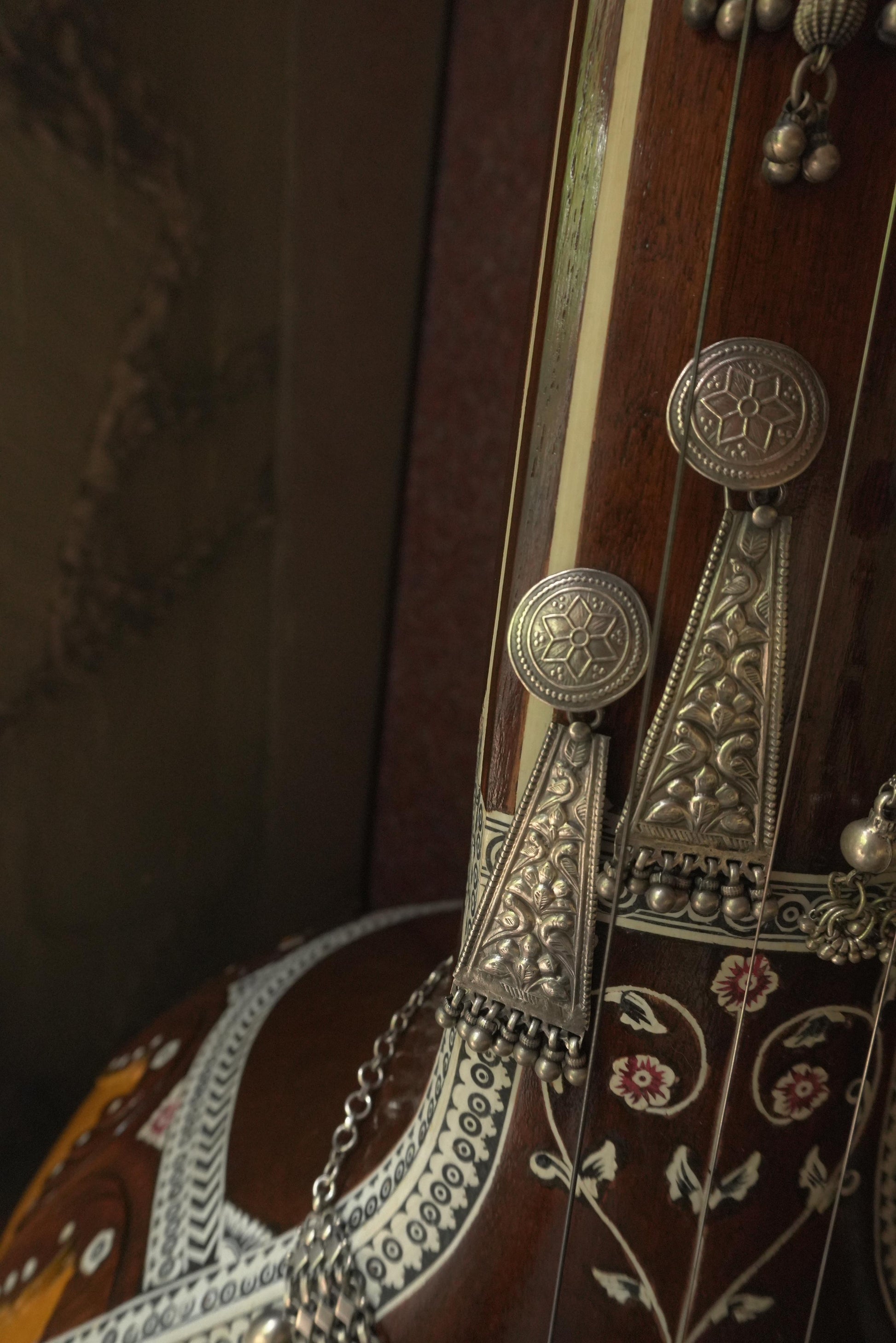 Tribal silver jewellery featuring 92.5 silver long triangular earrings with intricate engraved patterns and dangling beads.