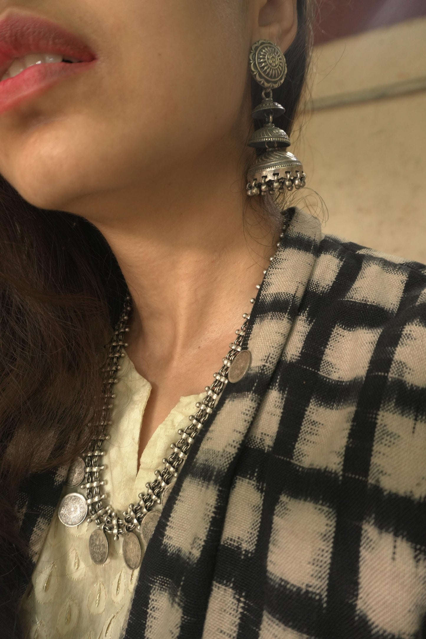 92.5 silver tribal earrings with intricate circular and jhumka design, worn with matching necklace.
