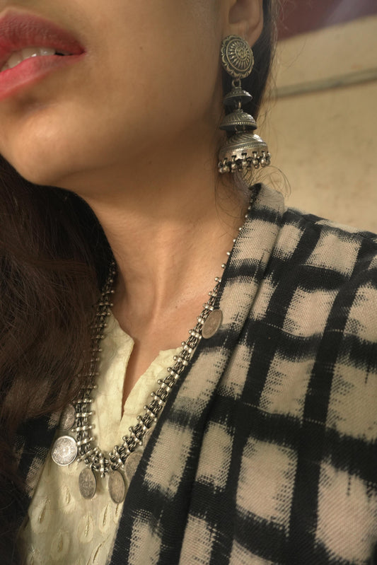 92.5 silver tribal earrings with intricate circular and jhumka design, worn with matching necklace.