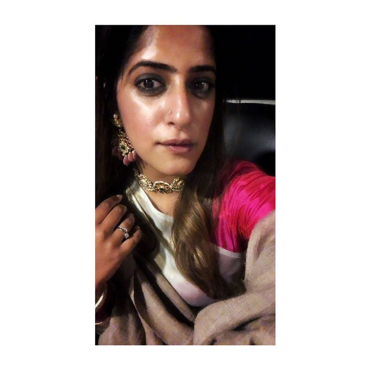 Happy Client showing her Abharika earrings with pink rhodonite stones by Aaharya